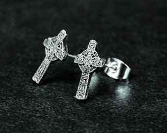 May include: A pair of silver Celtic cross stud earrings. The earrings are detailed with intricate designs and have a polished finish.