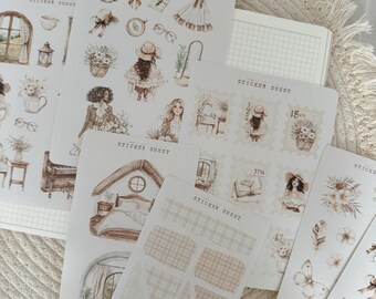 Pode incluir: Um conjunto de 8 folhas de adesivos com ilustrações em aquarela de um quarto, uma casa, um piano, uma janela, uma menina, uma cesta de flores, um livro e uma borboleta. Os adesivos estão em um fundo branco com um padrão de grade marrom claro.