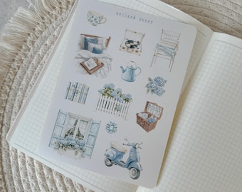 May include: A sticker sheet with a blue and white color scheme featuring various illustrations including a window with flowers, a scooter, a picket fence, a record player, a teapot, a chair, a picnic basket, and a bed with a pillow. The sticker sheet says "Sticker Sheet" at the top.