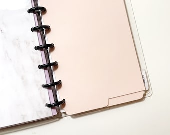 May include: A pink divider for a disc bound planner with a clear plastic sleeve and the word "Notes" printed on it.
