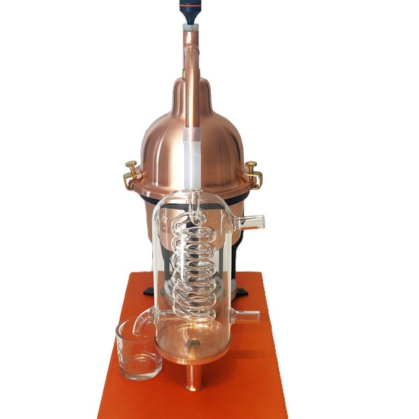Copper still for essential oils & hydrolates with glass condensation coil.