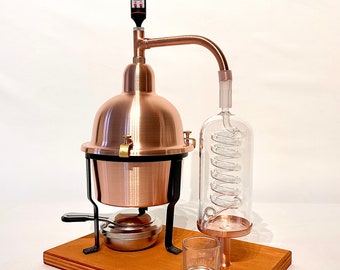 Alembic Distiller for essential oils in copper with glass condensation coil.