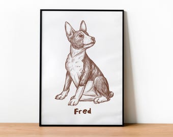 May include: A framed black and white line drawing of a dog sitting. The dog is brown and white with large ears and a long snout. The dog's name, "Fred", is written below the image.