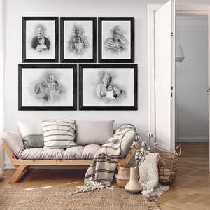 May include: Five black framed pencil drawings of different people, hanging on a white wall above a light brown couch with a white and black striped throw blanket. The drawings are all in a similar style, with a soft, hazy background.