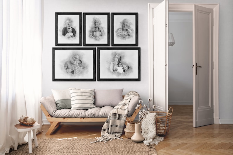 May include: Five black framed pencil drawings of different people, hanging on a white wall above a light brown couch with a white and black striped throw blanket. The drawings are all in a similar style, with a soft, hazy background.