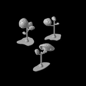 Puede incluir: Tres árboles en miniatura de color gris, impresos en 3D, con una superficie craterizada similar a la de la luna. Los árboles están sobre una base blanca.