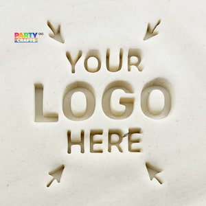 May include: A close-up of a light-colored stamp with the words "YOUR LOGO HERE" carved into it. Arrows point towards the text. The logo "PARTY CRAFTS" is in the upper left corner.