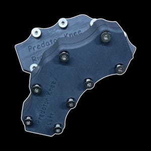 May include: Two dark blue Predator Knee guards with silver bolts. The text "Predator Knee Right" and "Predator Knee Left" are visible on the guards. The guards are set against a black background.