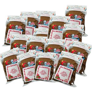 May include: Multiple clear plastic bags containing gingerbread house kits. Each bag has a brown gingerbread house base, decorative candies, and a card that reads "Make Your Own Gingerbread House". The bags are sealed with a festive holiday design.