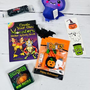 Puede incluir: Una colecci&oacute;n de art&iacute;culos con tem&aacute;tica de Halloween, que incluye un murci&eacute;lago de peluche, un libro de actividades con pegatinas, un mini rompecabezas, una bolsa de ladrillos de construcci&oacute;n y un recipiente de Play-Doh. El libro de pegatinas presenta ilustraciones de monstruos.