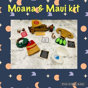 May include: A Moana and Maui themed craft kit with a variety of items, including a small wooden boat, a green wreath, a brown felt vest, a green felt skirt, a blue seashell, a blue gem, and several cards with text. The text on the cards includes "Maui demigod, demigod of the wind and sea, hero of men", "What can I do for you?", and "I am Moana of Motunui. You will sail across the vast sea and restore the heart to Te Fiti."