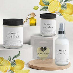 May include: A collection of lemon parsley scented products, including a soy candle, room spray, wax melt, and car air freshener. The candle and spray are in clear glass bottles with black lids and labels. The wax melt is heart-shaped.