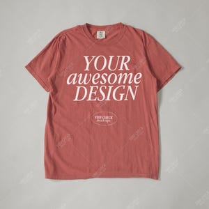May include: A red t-shirt with the text "YOUR awesome DESIGN" printed in white on the front.