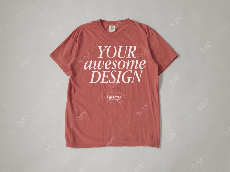 May include: A red t-shirt with the text "YOUR awesome DESIGN" printed in white on the front.
