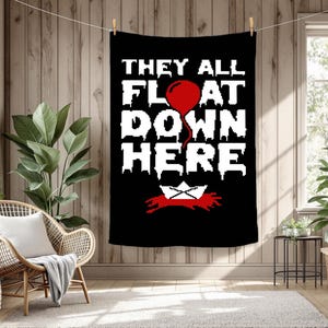 May include: Black tapestry with the text "THEY ALL FLOAT DOWN HERE" in white, a red balloon, and a paper boat. The tapestry is hanging on a wooden wall.