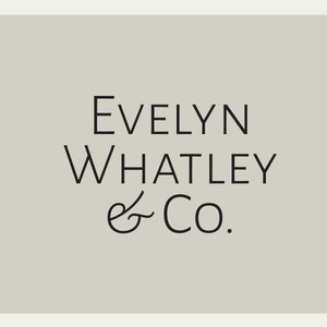 May include: Black and white text logo on a light gray background. The logo reads "Evelyn Whatley & Co."
