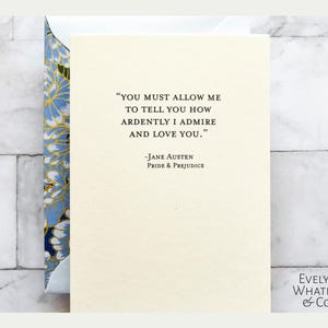 May include: A white card featuring a quote from Jane Austen's Pride and Prejudice: "You must allow me to tell you how ardently I admire and love you." The card is decorated with a blue and gold floral pattern.