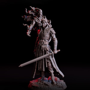 May include: A detailed figurine of a warrior holding a sword, with a spectral figure behind him. The warrior is clad in armor and a long coat, standing on a rocky base. The background is black, with red lighting.