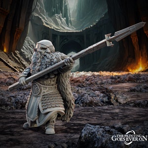 May include: A miniature figurine of a dwarf warrior wearing a fur-lined cloak and holding a spear with a detailed metal tip. The dwarf has a beard and an eyepatch. The figurine is painted in a light gray color.