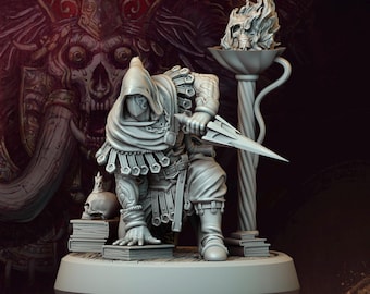 May include: A gray figurine of Nassahir the Masked, from the Orc Legacy Wrath of the Grimskorn series. The figure is holding a dagger and is wearing a hooded cloak and armor. A flaming skull sits atop a decorative column. The text "Archvillain Society XXXVII" and "Nassahir the Masked" are visible.