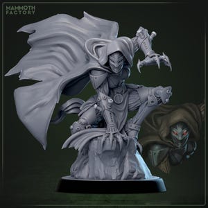 May include: A gray figurine of a hooded character in a dynamic pose, perched on a rocky base. The figure has a mask, mechanical arm, and clawed hand. A cape flows behind it. A smaller version of the figure is in the background. The text "MAMMOTH FACTORY" is in the upper left corner.