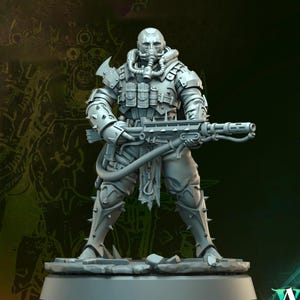 May include: A gray miniature figure of a soldier in futuristic armor, holding a large weapon. The figure wears a helmet with a respirator, and the armor has multiple pouches and spiked details. The figure stands on a rocky base.