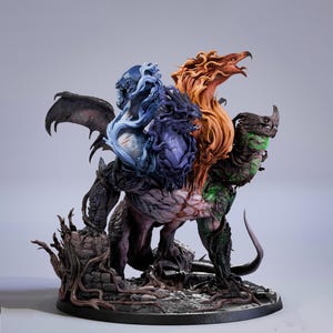 May include: A detailed fantasy figurine depicting a multi-headed creature with wings. The sculpture features a combination of colors, including blue, orange, and green, with intricate detailing. The base is a dark gray, and the overall design suggests a mythical theme.