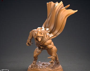 May include: A tan-colored miniature figure of a humanoid creature with a hooded cloak, posed in a dynamic stance. The figure is on a circular base with small rocks. The text "HETFIELD" and "JANUARY 2022" are visible. The miniature is pre-supported for 3D printing.