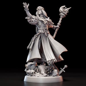 May include: A gray resin tabletop miniature figure of a spellcaster wearing ornate armor and a long robe. The figure holds a staff with a crystal top in one hand and gestures with the other. It stands on a base featuring a skull and sword.