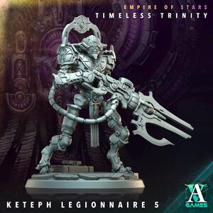 May include: A grey miniature figure of a Ketep Legionnaire 5, a futuristic warrior from the Empire of Stars Timeless Trinity. The figure is holding a large weapon and is posed in a dynamic stance. The figure is on a base with the A Games logo.
