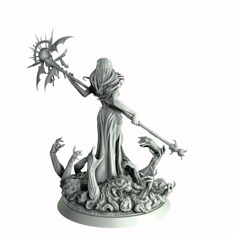May include: A gray painted miniature figurine of a female figure with long hair, wearing a flowing robe and holding a staff with a sun-like orb at the top. The figure is standing on a base with multiple skeletal hands reaching up.