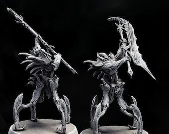 May include: Two grey fantasy figures with detailed designs stand on circular bases against a black background. One figure holds a spear, the other a large scythe. The figures have an intricate, organic design, with a textured appearance.