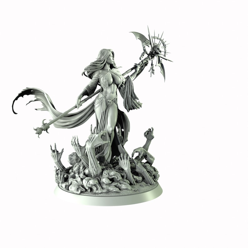 May include: A gray, detailed miniature figurine of a woman with long hair, wearing a flowing robe and holding a staff with a skull at the top. The figure is standing on a base with skeletal hands reaching up.