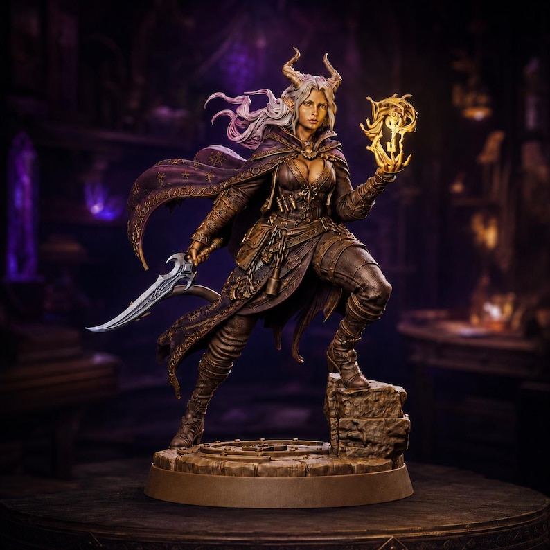 May include: A detailed fantasy figurine of a horned character with long hair, wearing a dark brown leather outfit and a purple cape. The figure holds a glowing golden magical orb in one hand and a silver curved dagger in the other, standing on a stone base.