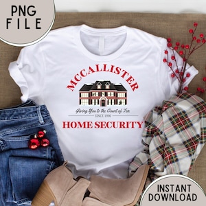 May include: White t-shirt with a red and black graphic of a house with the text "McCallister Giving You to the Count of Ten Since 1990 Home Security".