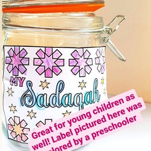 May include: A clear glass jar with a metal latch and a white label. The label has a colorful design with stars and the word "MY Sadagah". The label also includes the text "Great for young children as well! Label pictured here was colored by a preschooler."