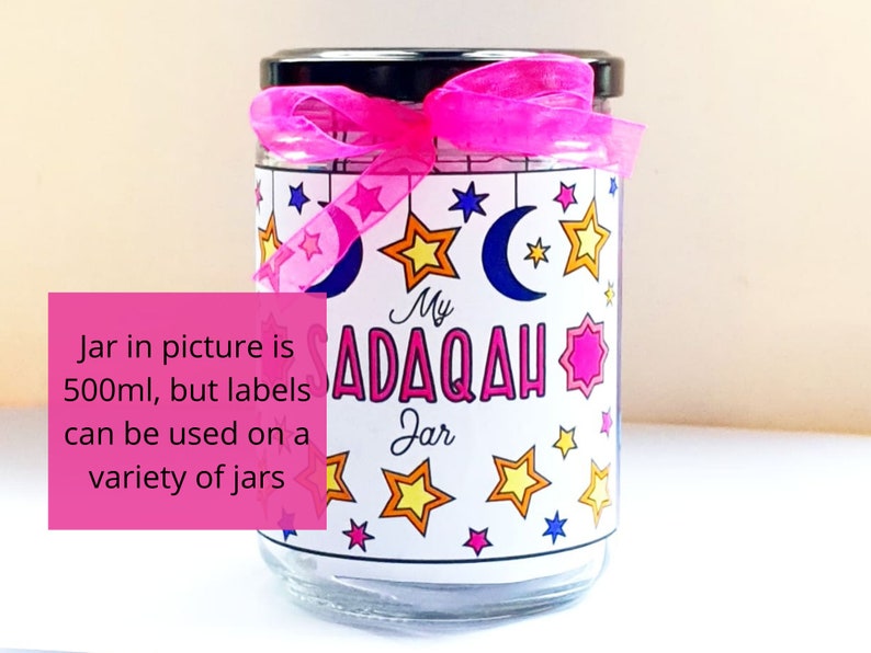 May include: A clear glass jar with a pink ribbon and a white label that says "My Sadaqah Jar". The label has a crescent moon and stars in various colors. The jar is 500 ml, but the labels can be used on a variety of jars.