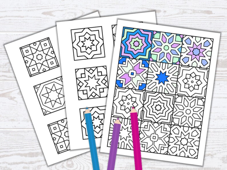 May include: Three white sheets of paper with geometric designs for coloring. One sheet is partially colored with blue, pink, and purple. Colored pencils in blue, purple, and pink are placed near the sheets.