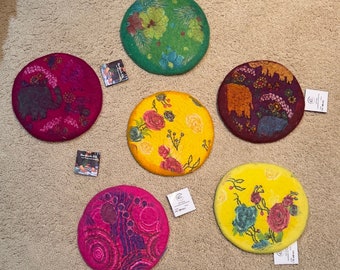 FAIRE TRADE:  Beautiful handmade cloth trivets from Nepal.  Various colors.  Hand-painted designs.