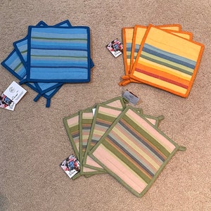May include: Set of six colorful striped pot holders.  The pot holders are made of a quilted fabric and have a loop for hanging.  The pot holders are in blue, green, and yellow.