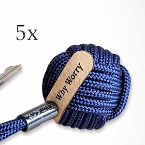 May include: A navy blue rope keychain with a leather tag that says "Why Worry".