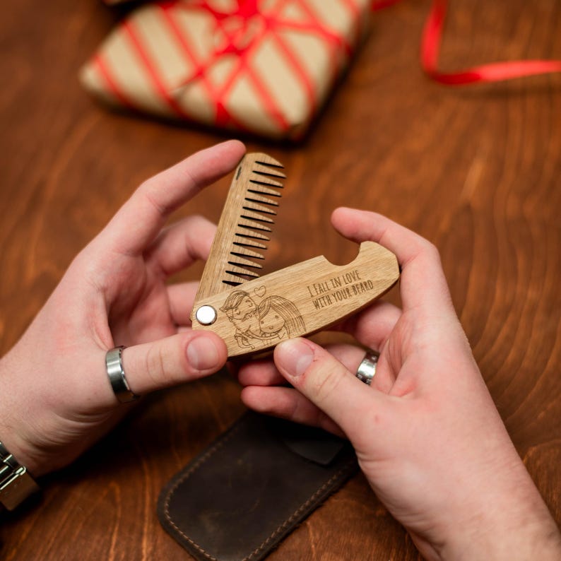 May include: A wooden pocket comb with a bottle opener and a laser engraved design of a couple with the text "I fall in love with your brand".