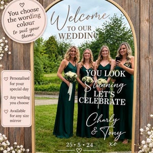 May include: An arched mirror with a gold frame featuring white vinyl decals that read Welcome TO OUR WEDDING, YOU LOOK Stunning LET'S CELEBRATE, Charly & Tony, and 25.5.24. The mirror reflects four people in green dresses holding bouquets.