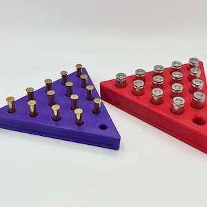 May include: Two triangular bullet storage trays, one purple and one red, with rows of bullet casings.