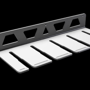 May include: A black metal wall mount with six slots for hanging items. The slots are white and have a slightly rounded edge.