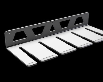 May include: A black metal wall mount with six slots for hanging items. The slots are white and have a slightly rounded edge.