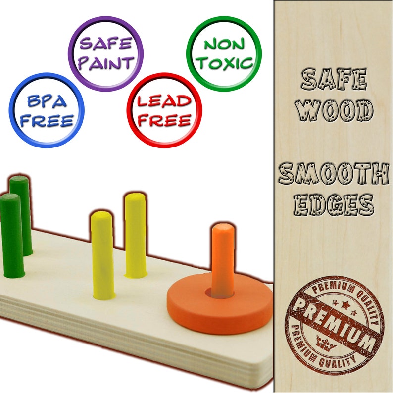May include: A wooden toy with coloured pegs and a ring. The pegs are green, yellow, and orange. The ring is orange. The base is light wood. Text on the image includes "Safe Paint", "Non Toxic", "BPA Free", and "Lead Free".