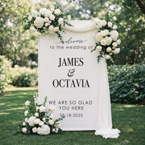 May include: White wedding welcome sign with black text. The sign reads "Welcome to the wedding of James & Octavia. We are so glad you are here. 08.18.2025".