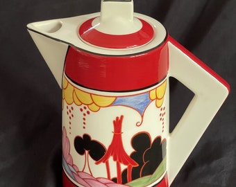 May include: A red and white ceramic teapot with a geometric design. The teapot has a spout and a handle. The design features a stylized landscape with trees, clouds, and flowers in shades of yellow, blue, pink, and black.