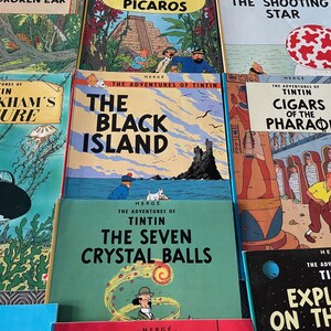Peut inclure: Plusieurs bandes dessin&eacute;es Tintin, avec des titres comme "L'Oreille Cass&eacute;e", "Tintin et les Picaros", et "L'&Icirc;le Noire". Les couvertures pr&eacute;sentent des illustrations color&eacute;es et des titres. D'autres titres incluent "L'&Eacute;toile Myst&eacute;rieuse" et "Les Sept Boules de Cristal".